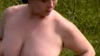 A sexy fatty masturbates outdoors